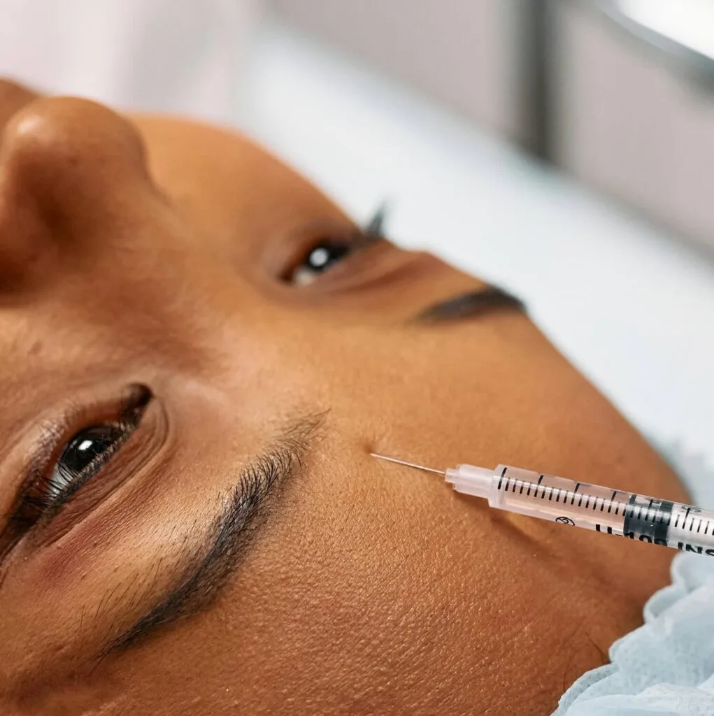 Blog about how to use injectable dermal fillers and to pick the right ones. jpg image with face and syringe