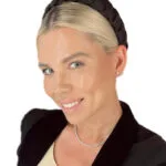 Beautiful blonde woman smiling dressed in black working in the beauty industry